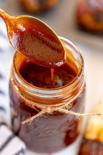 jar of homemade bbq sauce with a spoon.