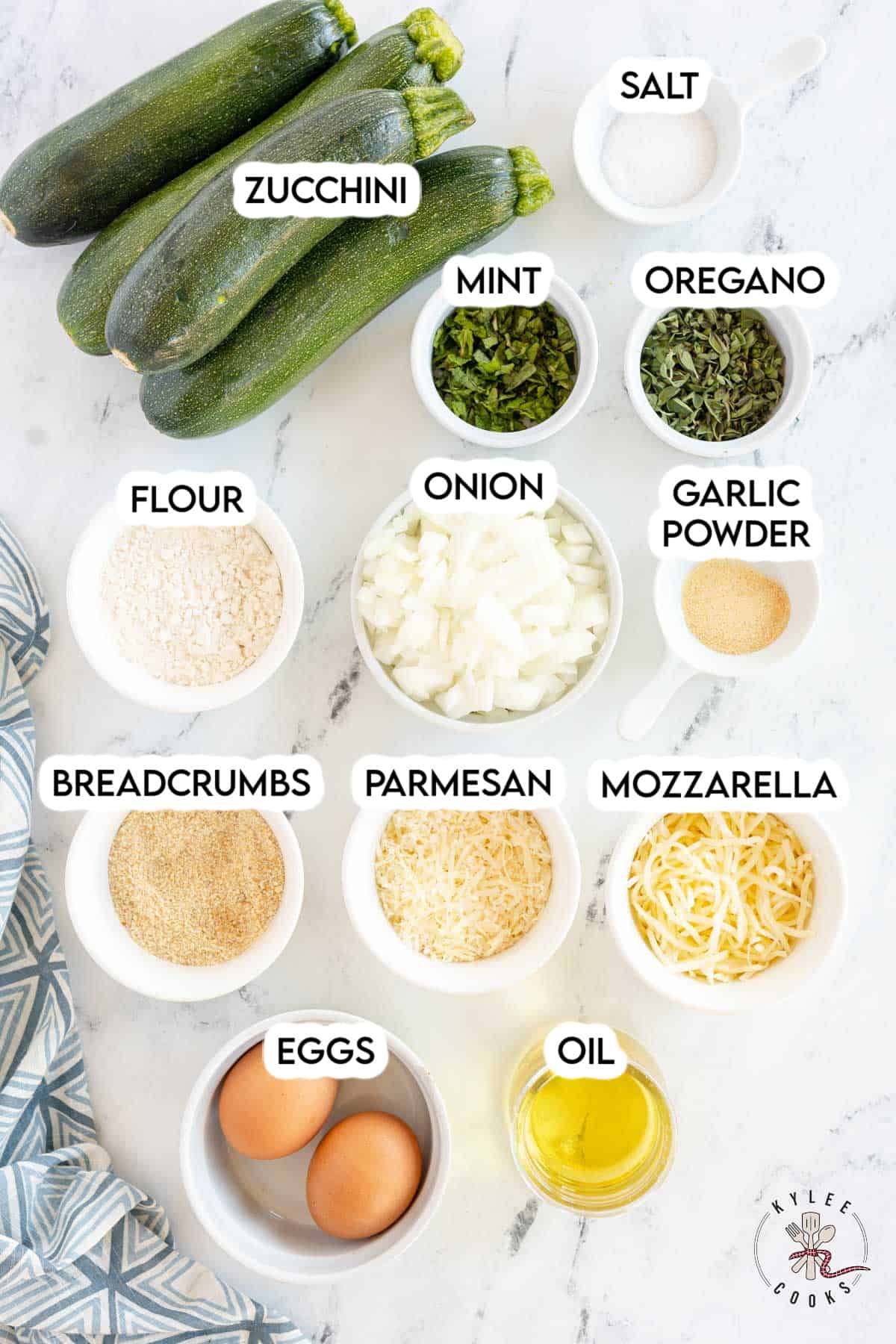 ingredients to make zucchini fritters laid out and labeled.