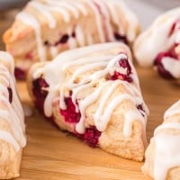 cranberry scones on a wooden cutting board.
