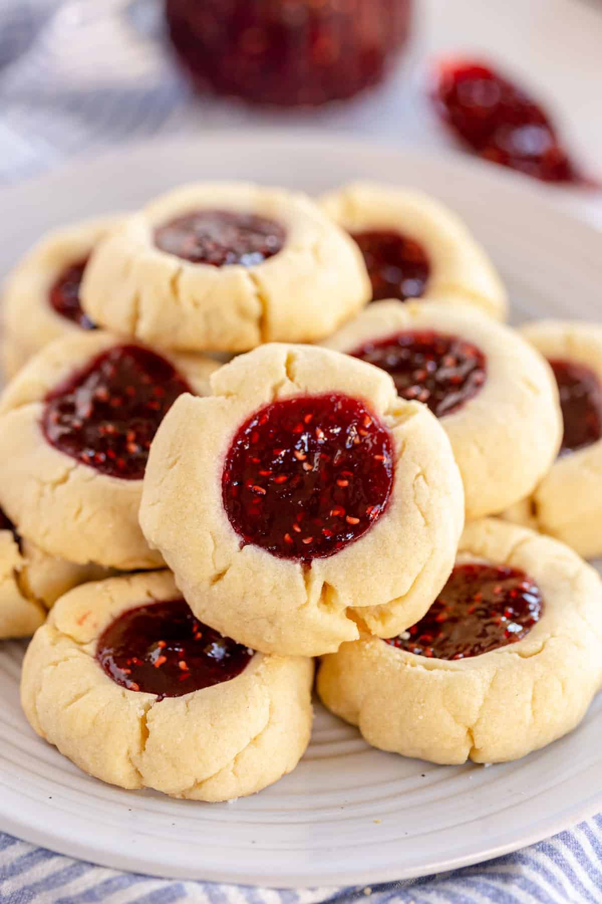 thumbprint cookies on a white plate.