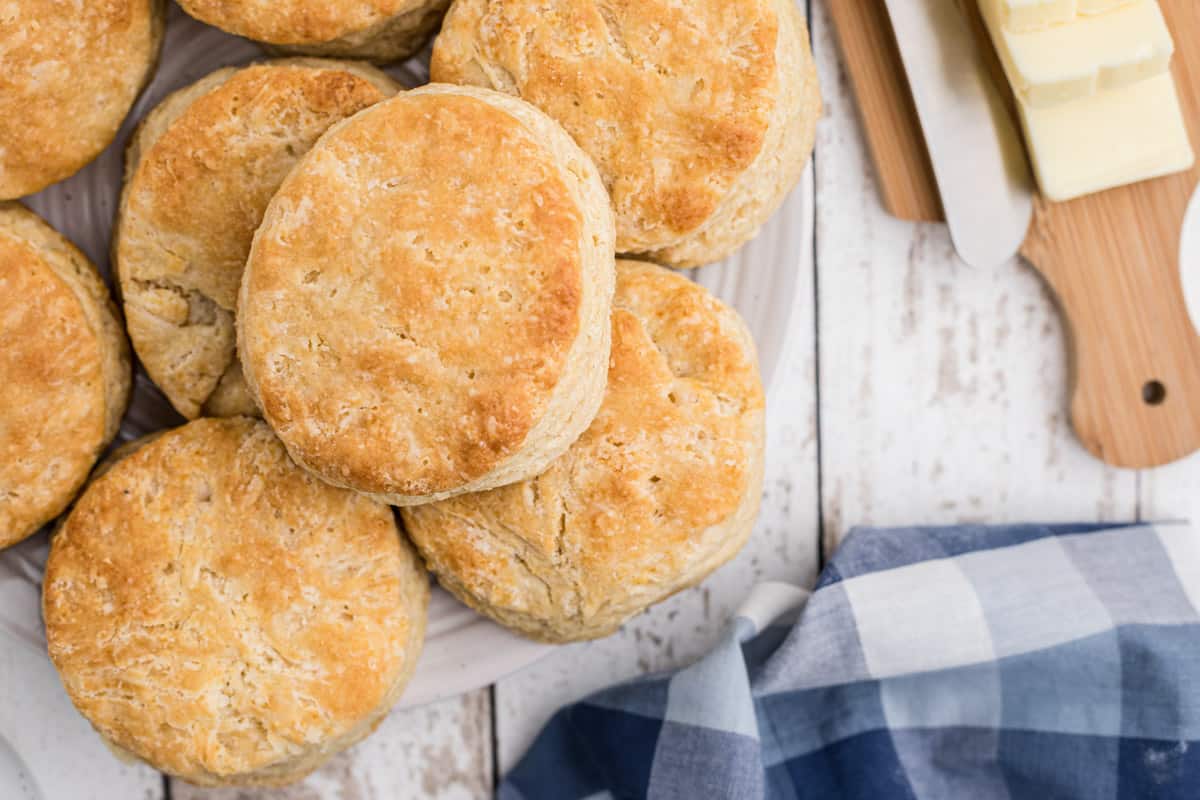 Buttermilk biscuits with butter and a plaid napkin.