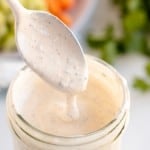 spoon of ranch dressing in a jar.