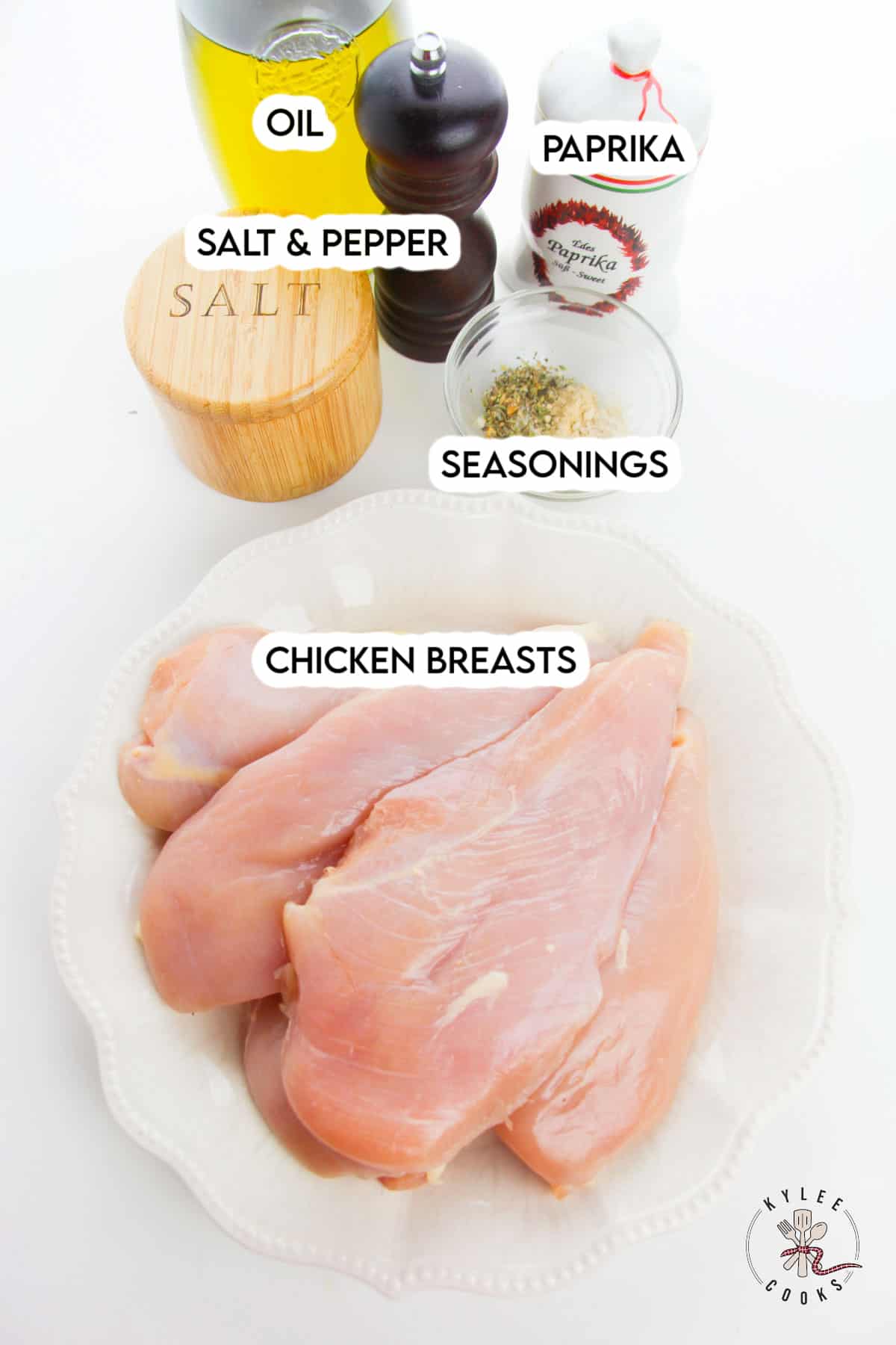 ingredients for baked chicken breasts laid out and labeled.