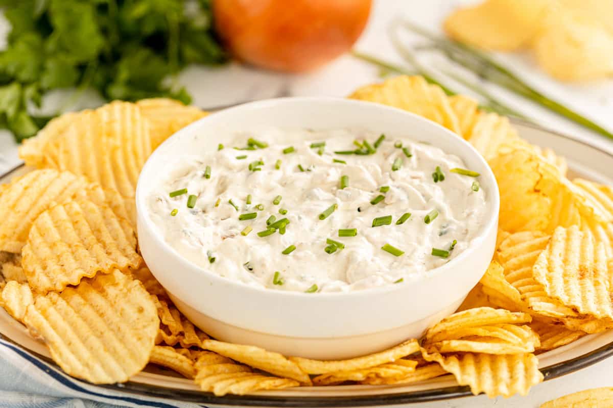 french onion dip in a bowl with chips.