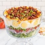 7 layer salad in a glass bowl.