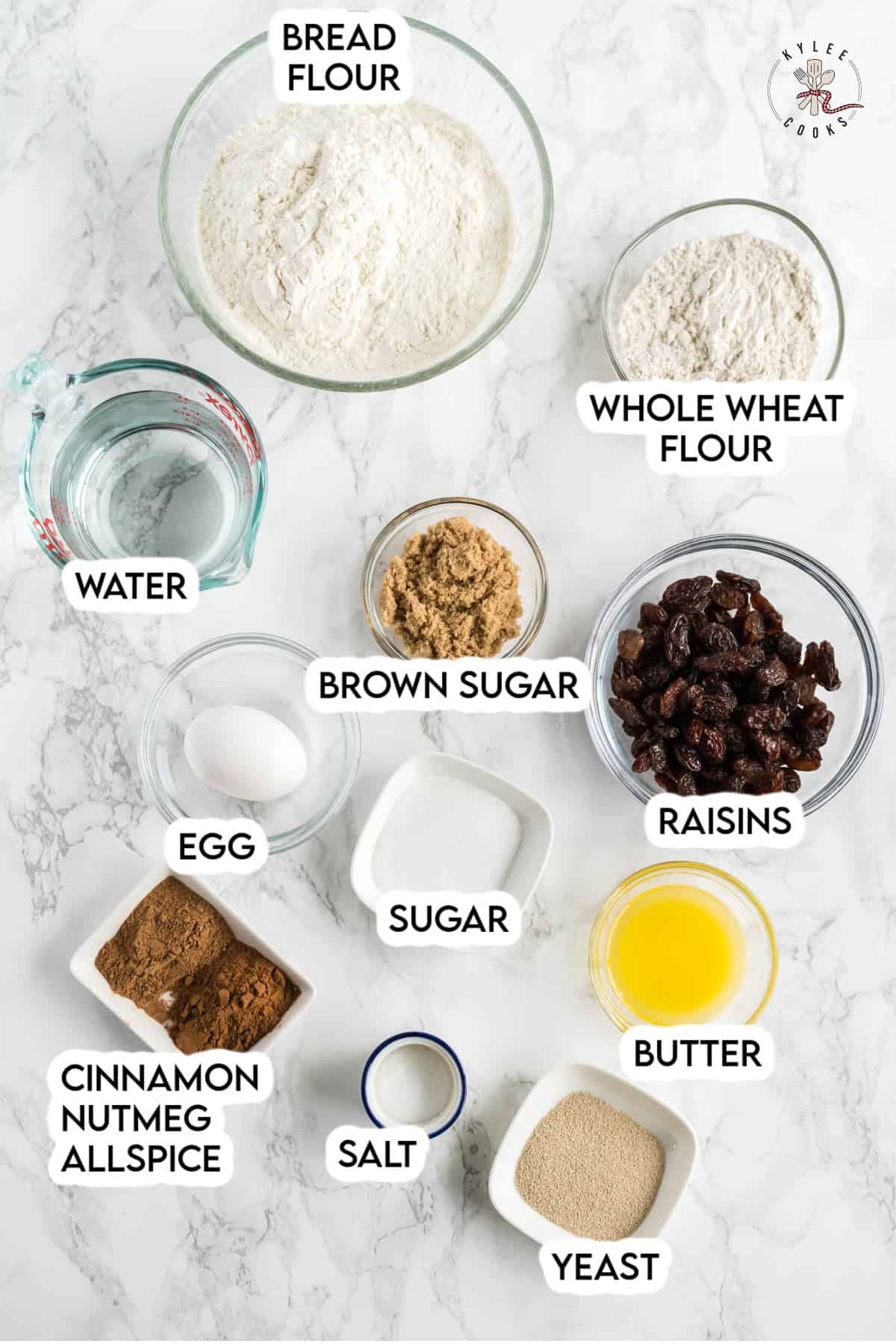 ingredients to make hot cross buns laid out and labeled.