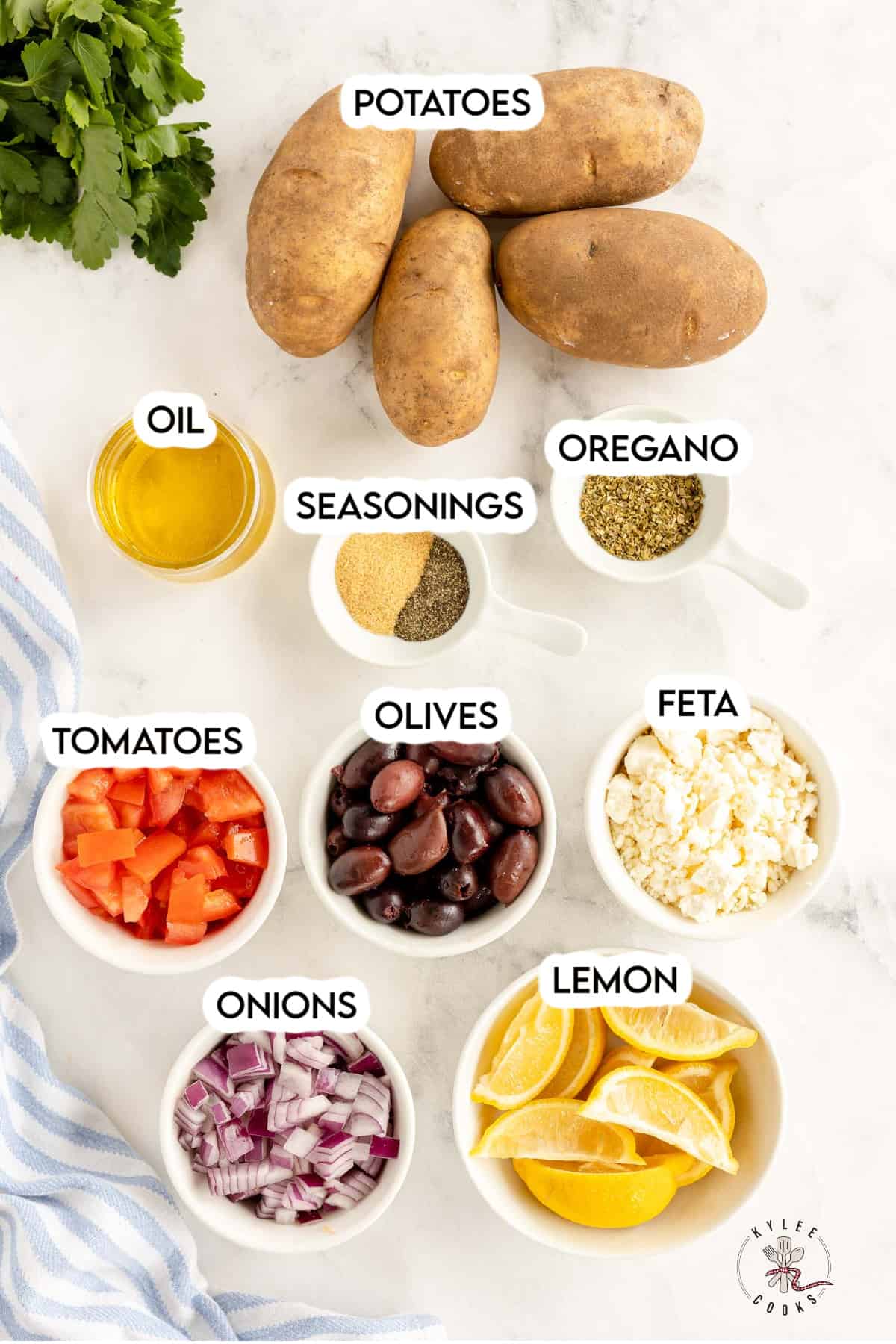 ingredients to make greek fries, laid out and labeled.