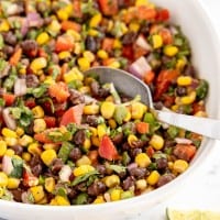 black bean salad in a bowl with a spoon.