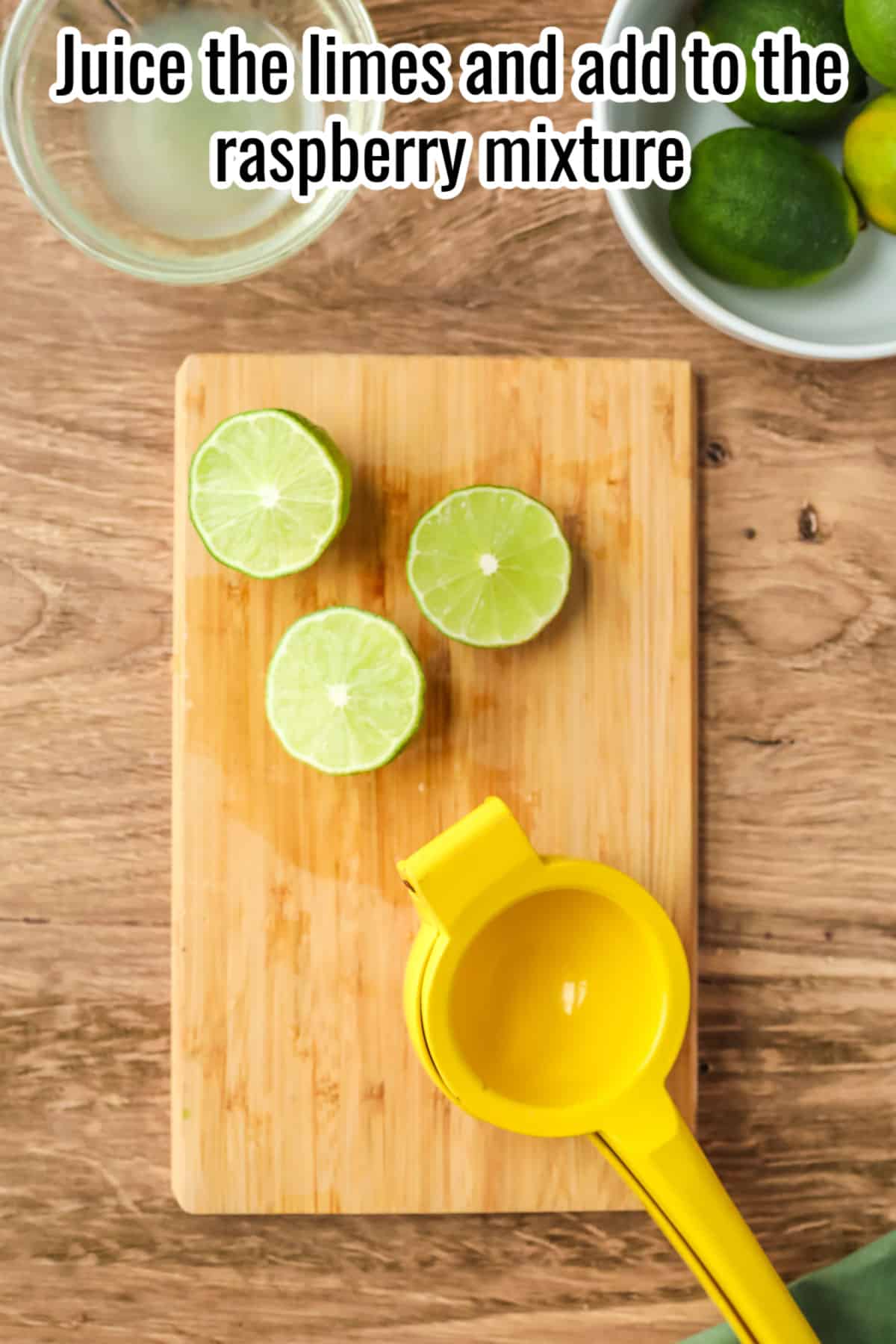 sliced limes on a wooden cutting board with a juicer.