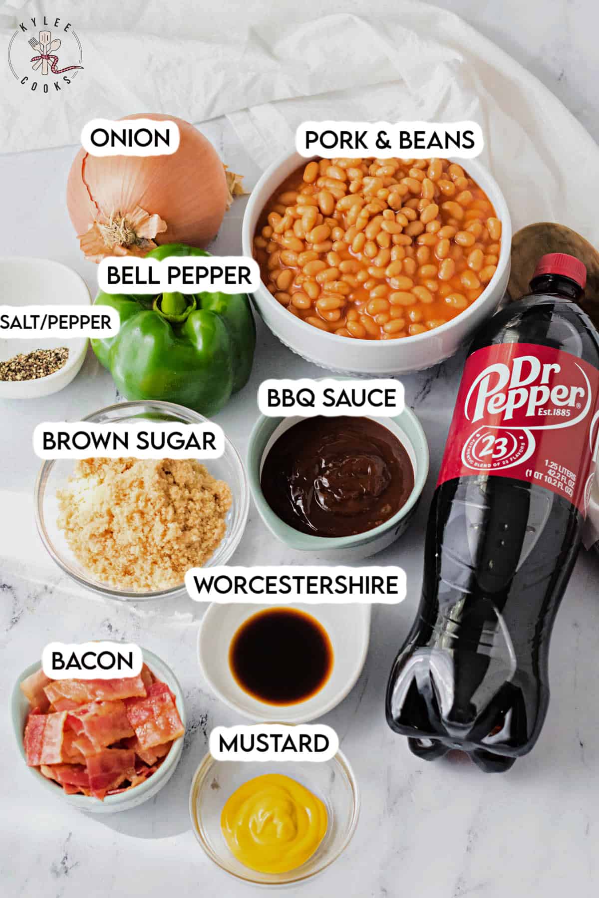 ingredients to make dr pepper baked beans laid out and labeled.