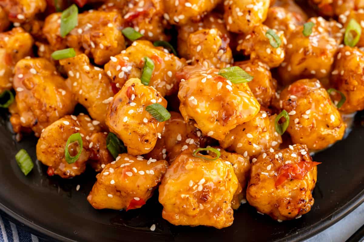 A plate of Bang Bang Chicken with sesame seeds.