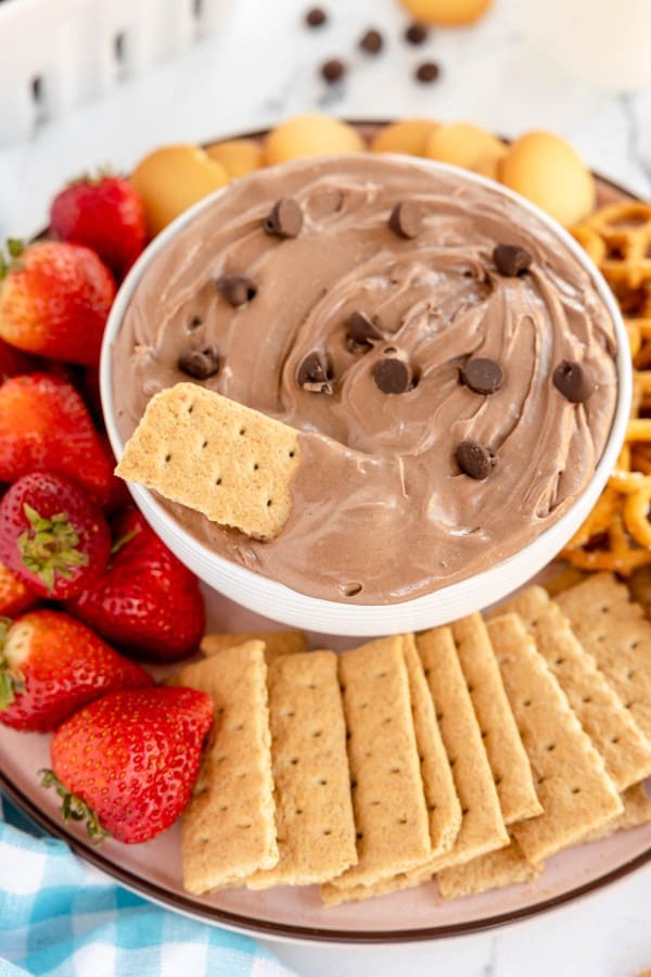 Brownie batter dip served with strawberries and crackers.