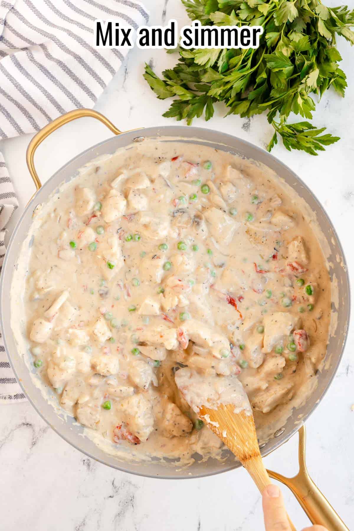 mixing chicken and a creamy sauce.