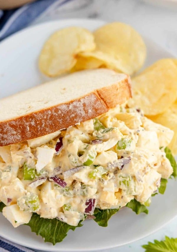 egg salad in a sandwich with lettuce.