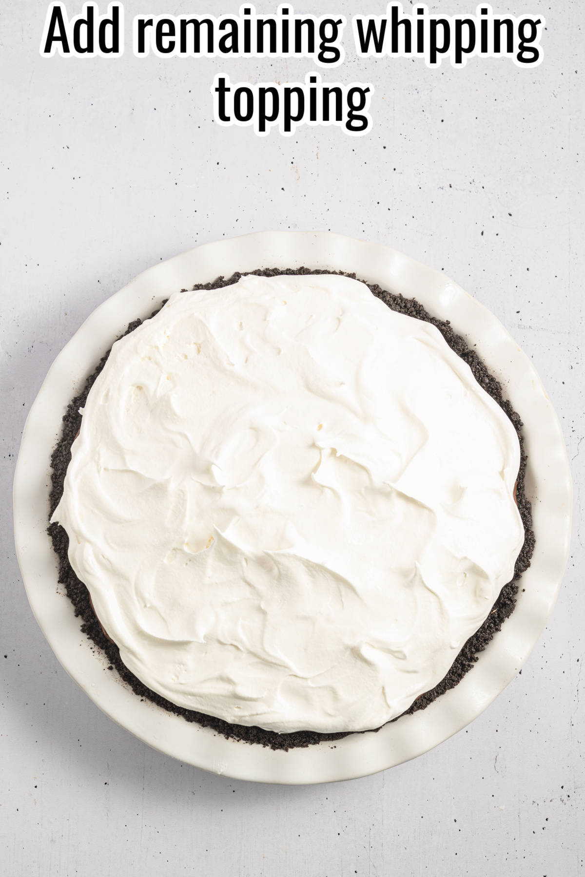 cool whip added to the top of a chocolate pie.