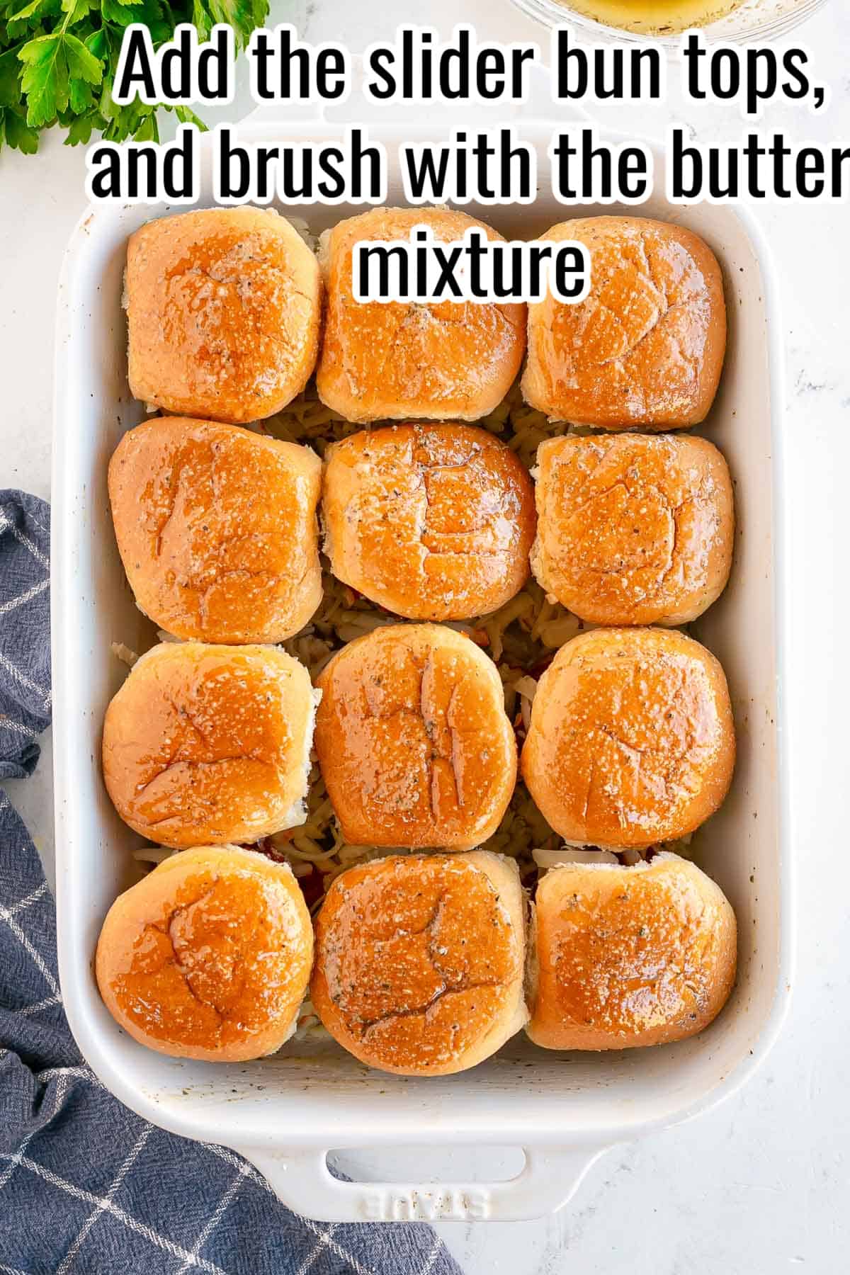 a white baking dish with sliders, unbaked.