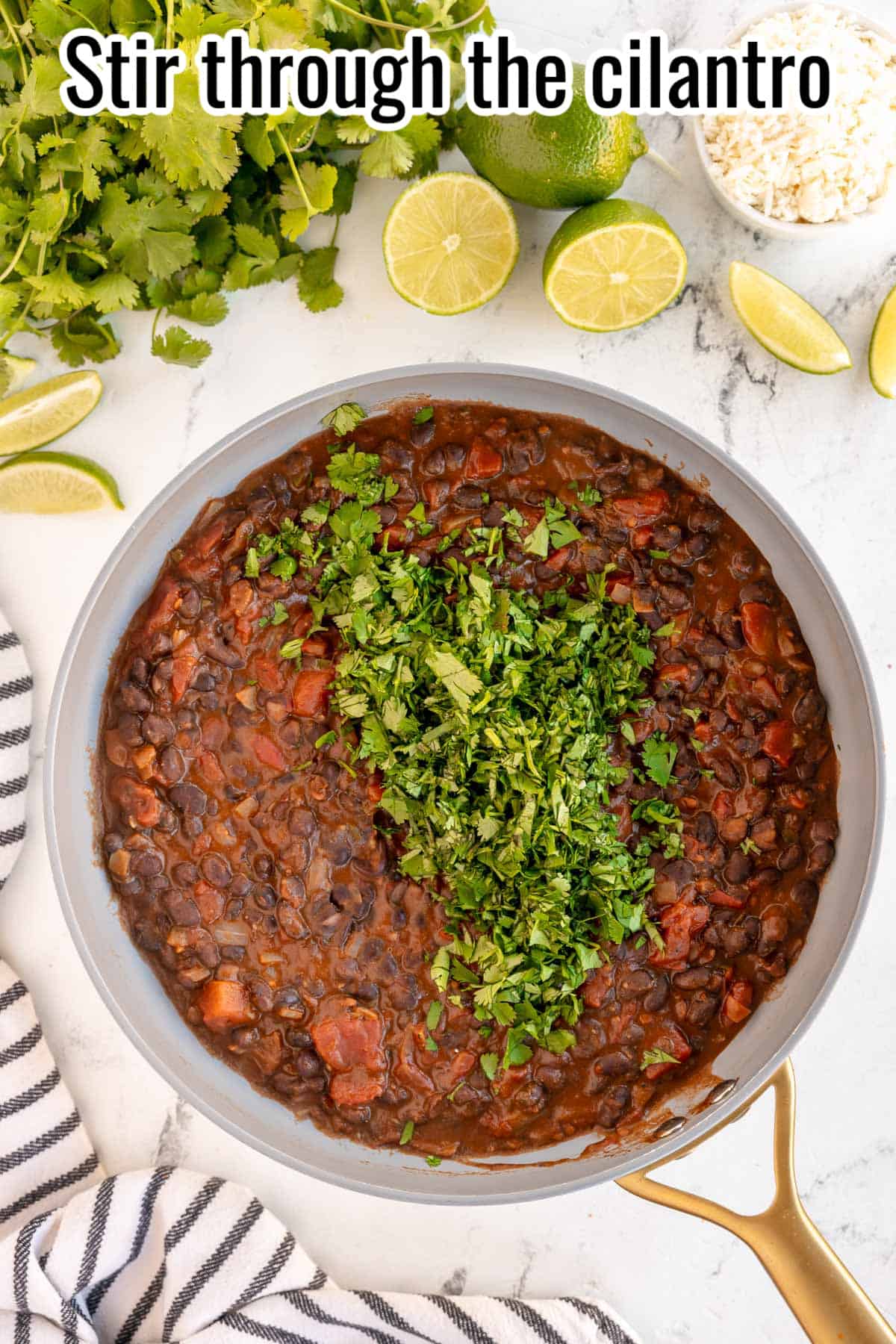 Skillet with black beans and text "stir through the cilantro".