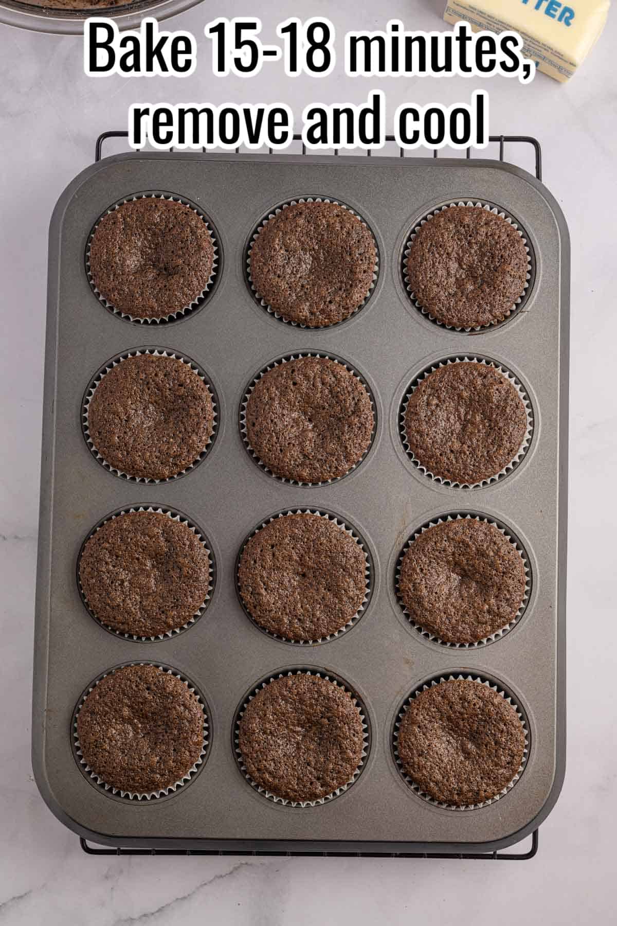 Chocolate cupcakes in a muffin tin with the words bake, remove, and cool.
