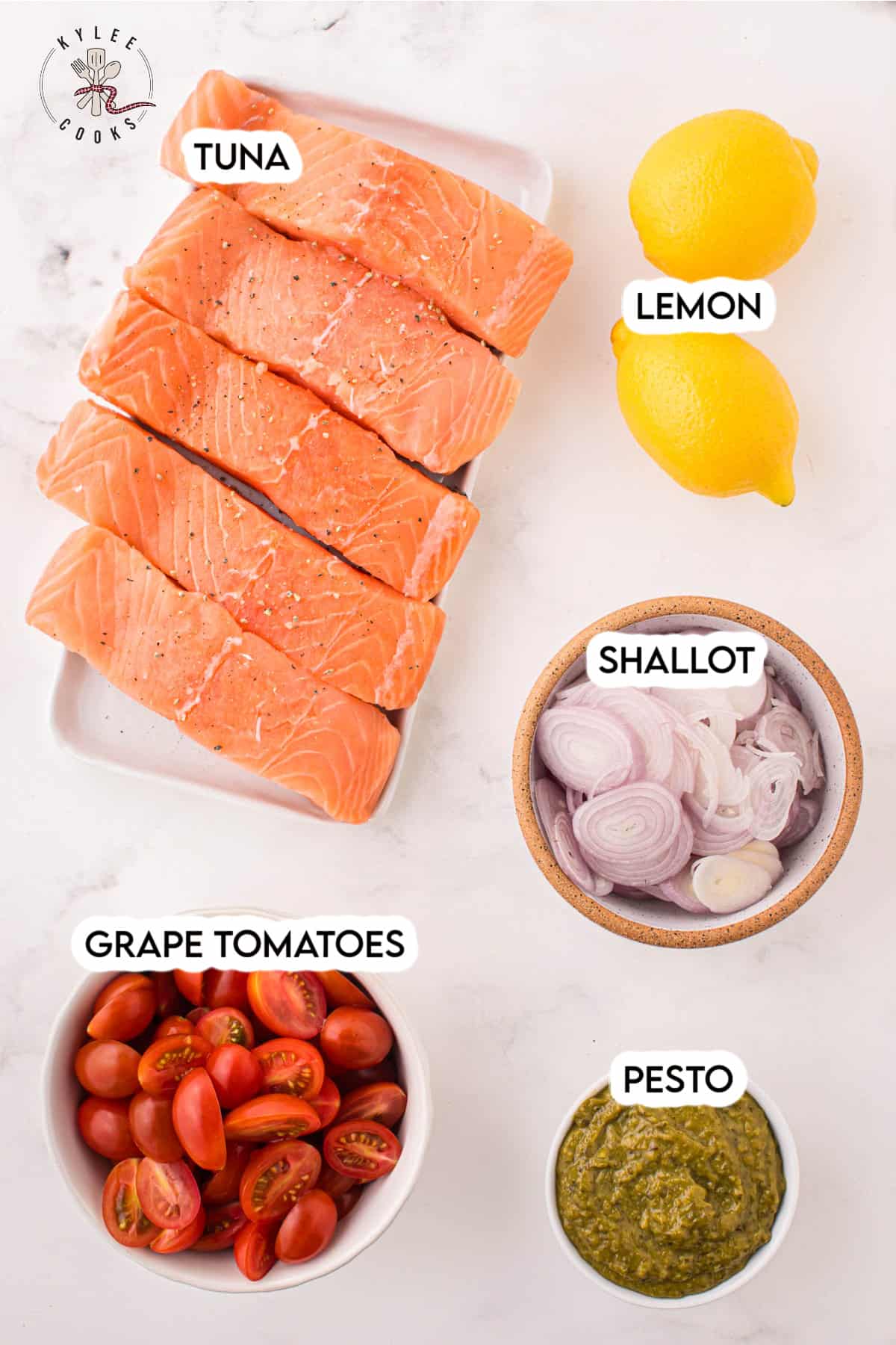 ingredients to make salmon with pesto laid out and labeled.