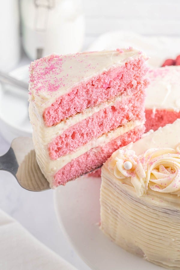 slice of pink velvet cake on a cake knife.