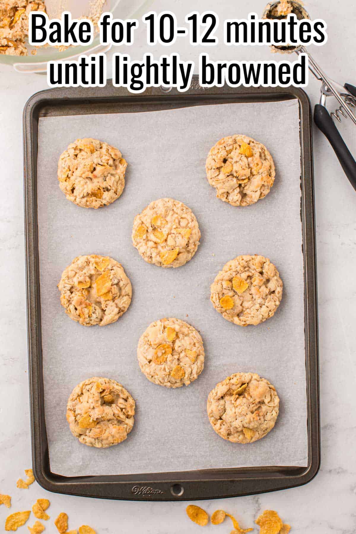baked cornflake cookies on a baking sheet.