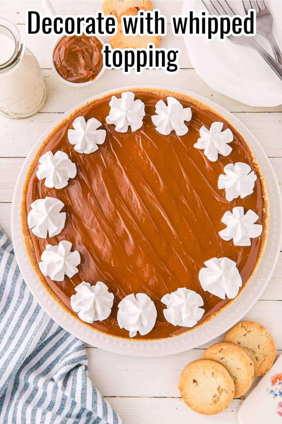 dulce de leche cheesecake with piped whipped topping on top.
