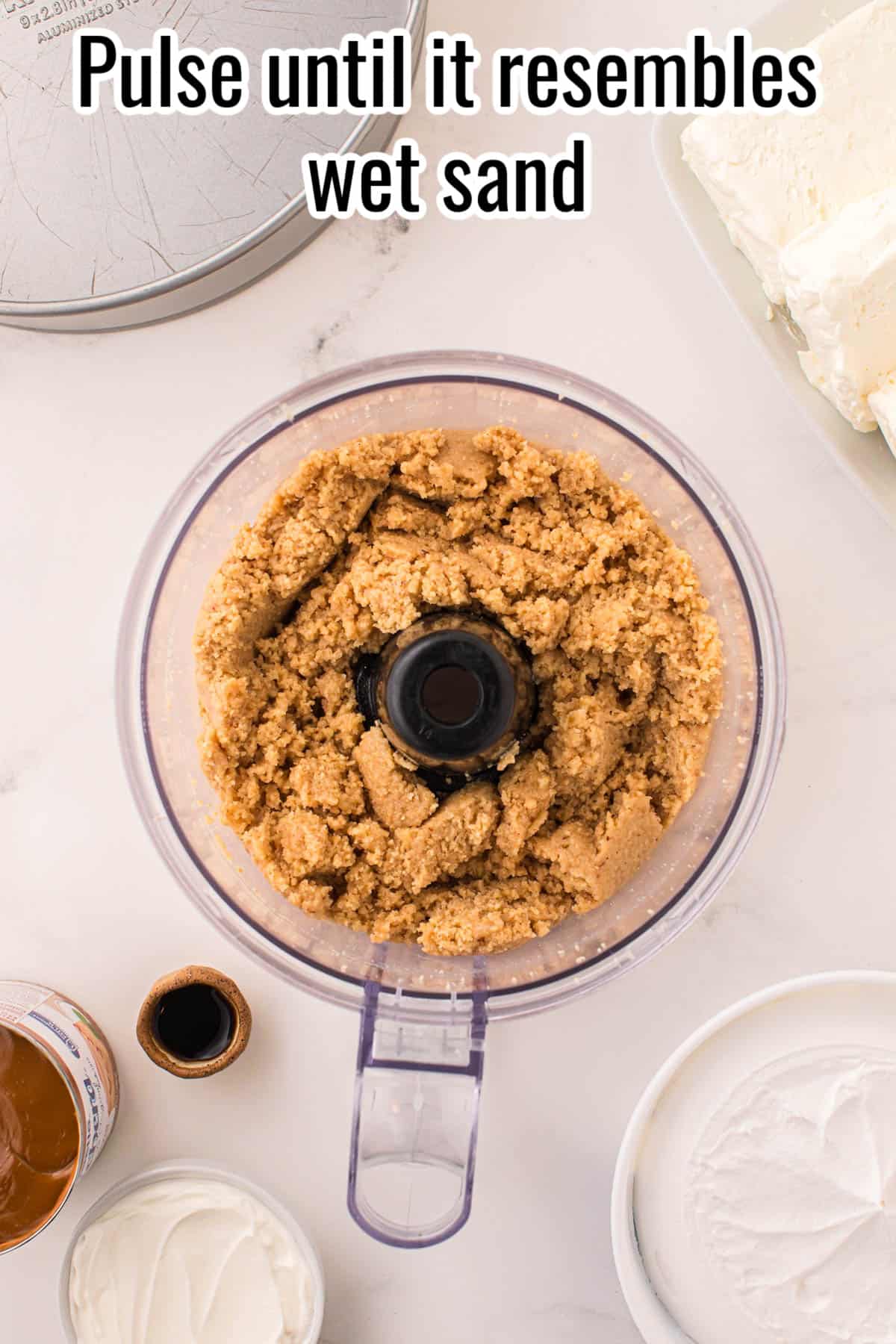 A food processor with mixed cheesecake crust.