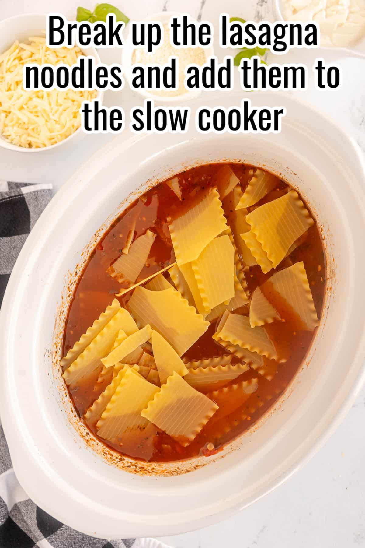 a slow cooker with uncooked lasagna noodles in it.