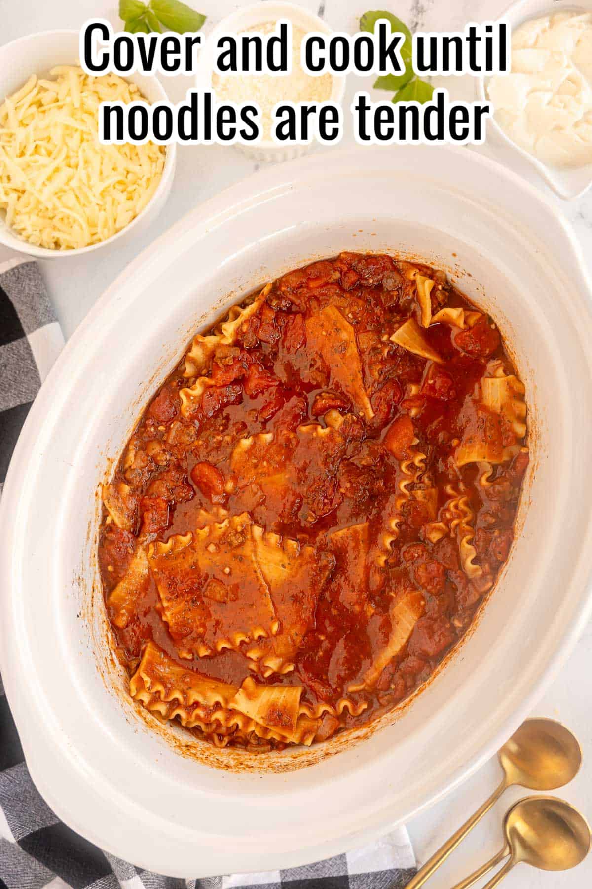 a slow cooker with lasagna soup in it.