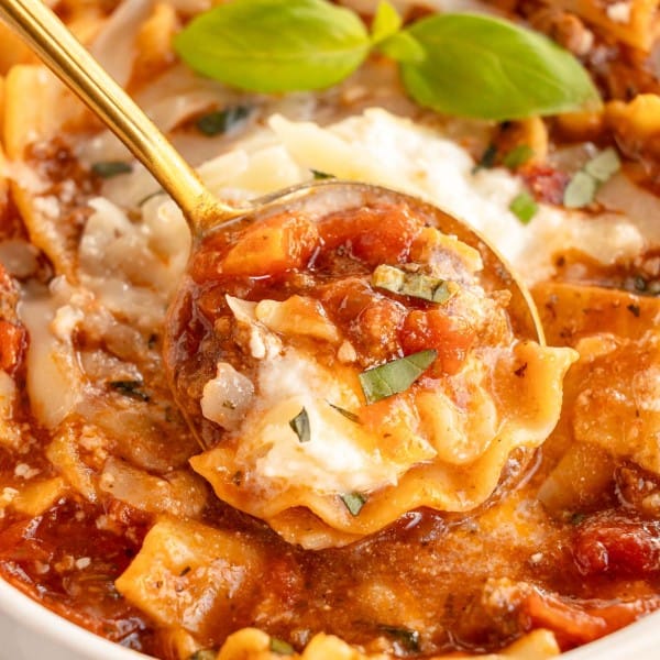 Slow cooker lasagna soup in a bowl with a spoon.