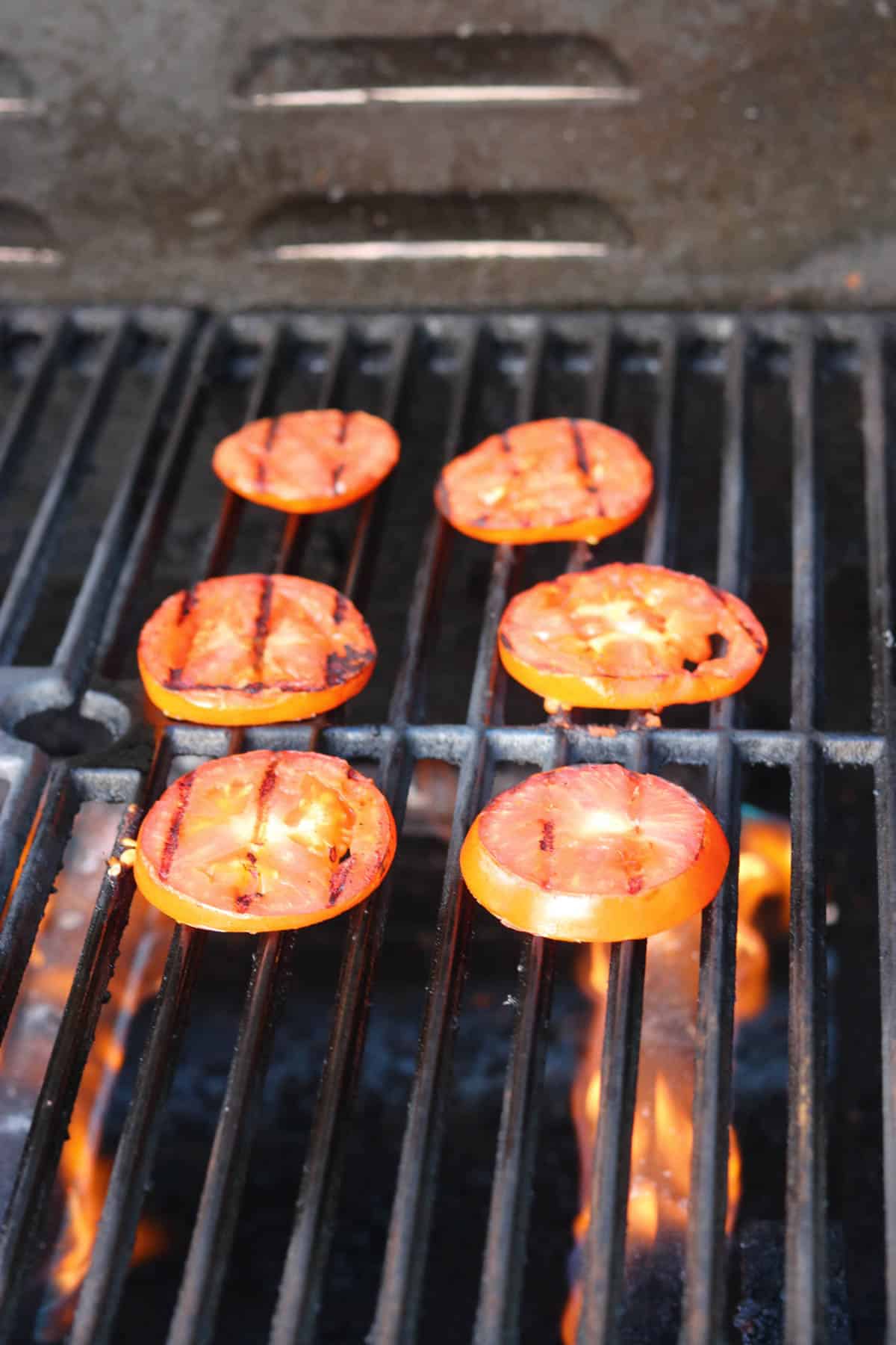 cooked tomato slices on a grill.
