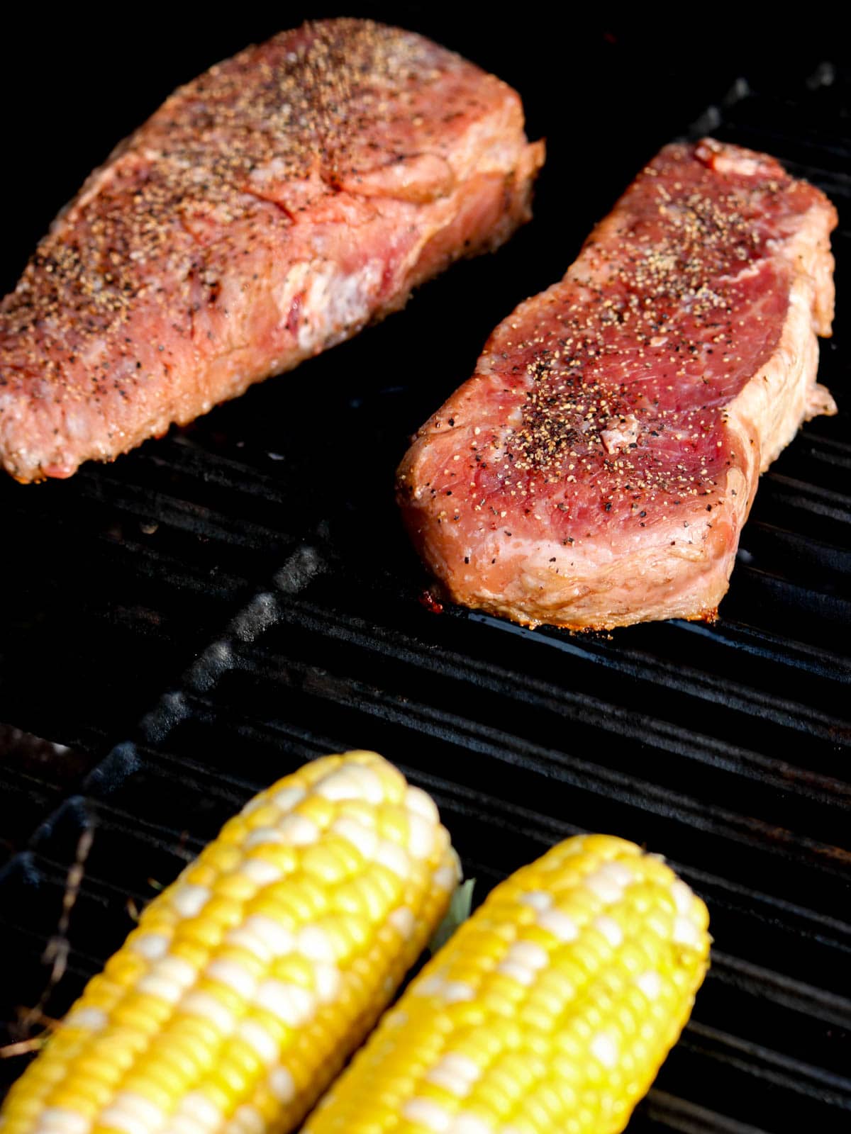 uncooked steak on a grill.