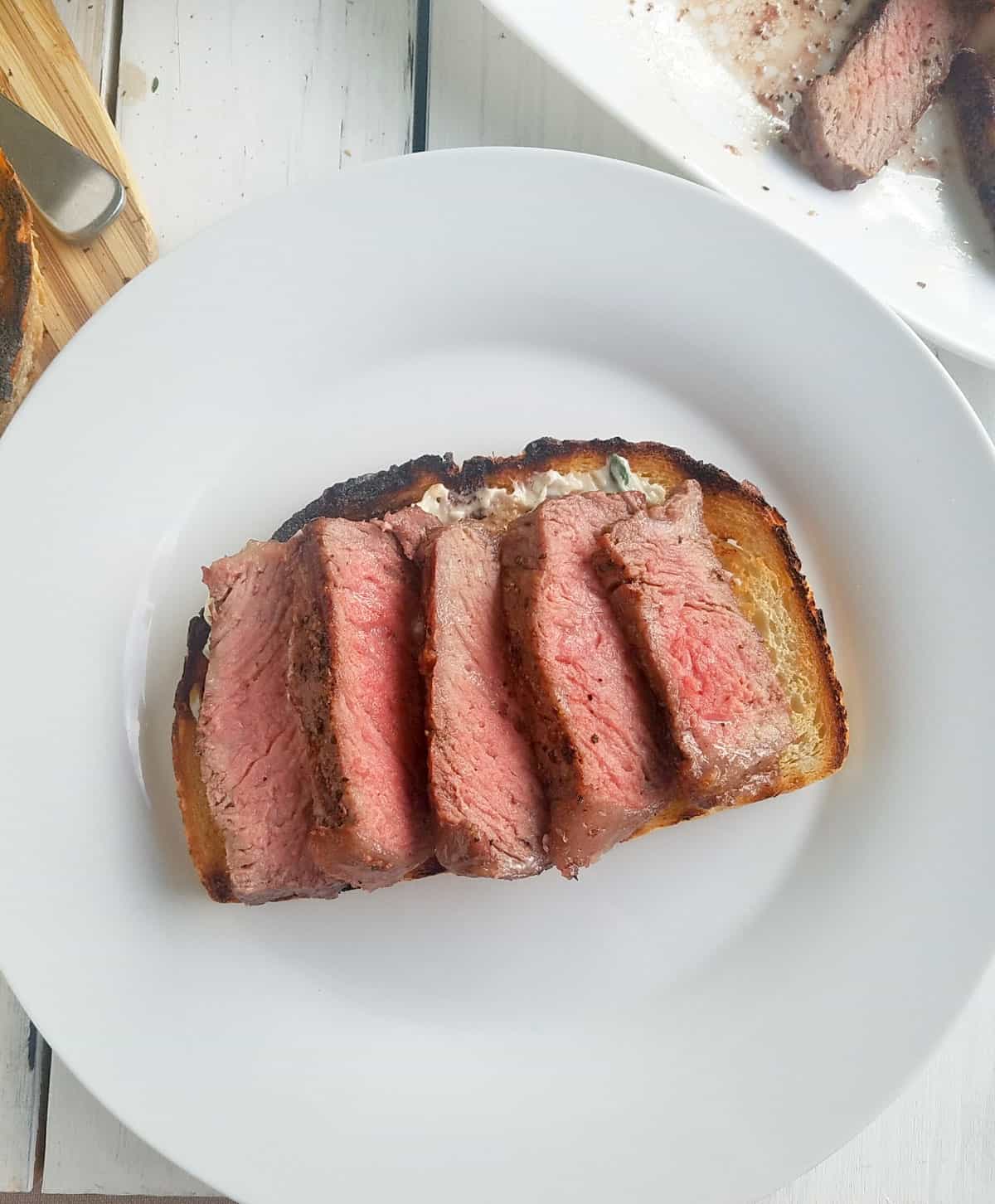 sliced steak on grilled bread.