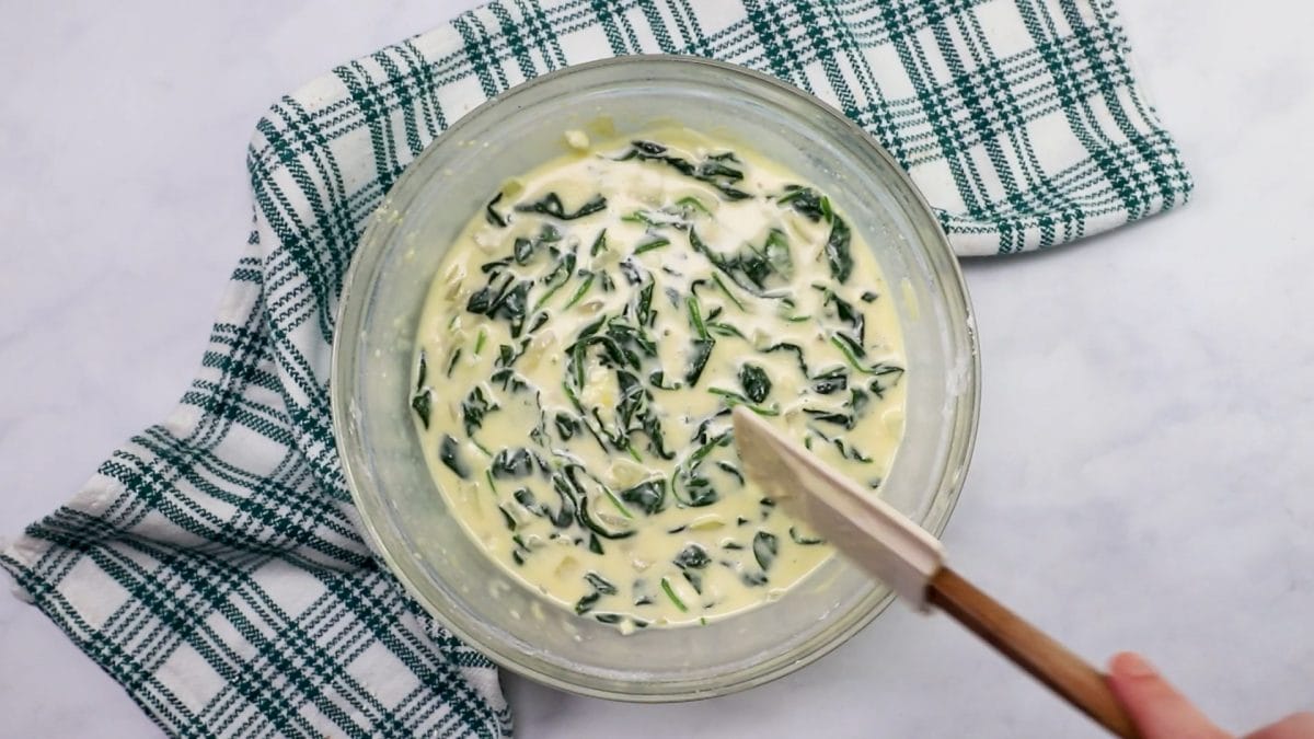 quiche batter with spinach added and mixed.