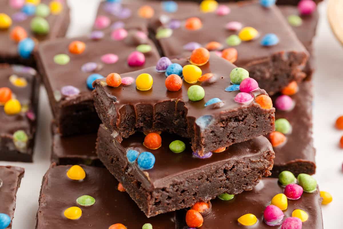 Two stacked cosmic brownies with a bite taken out of the top.