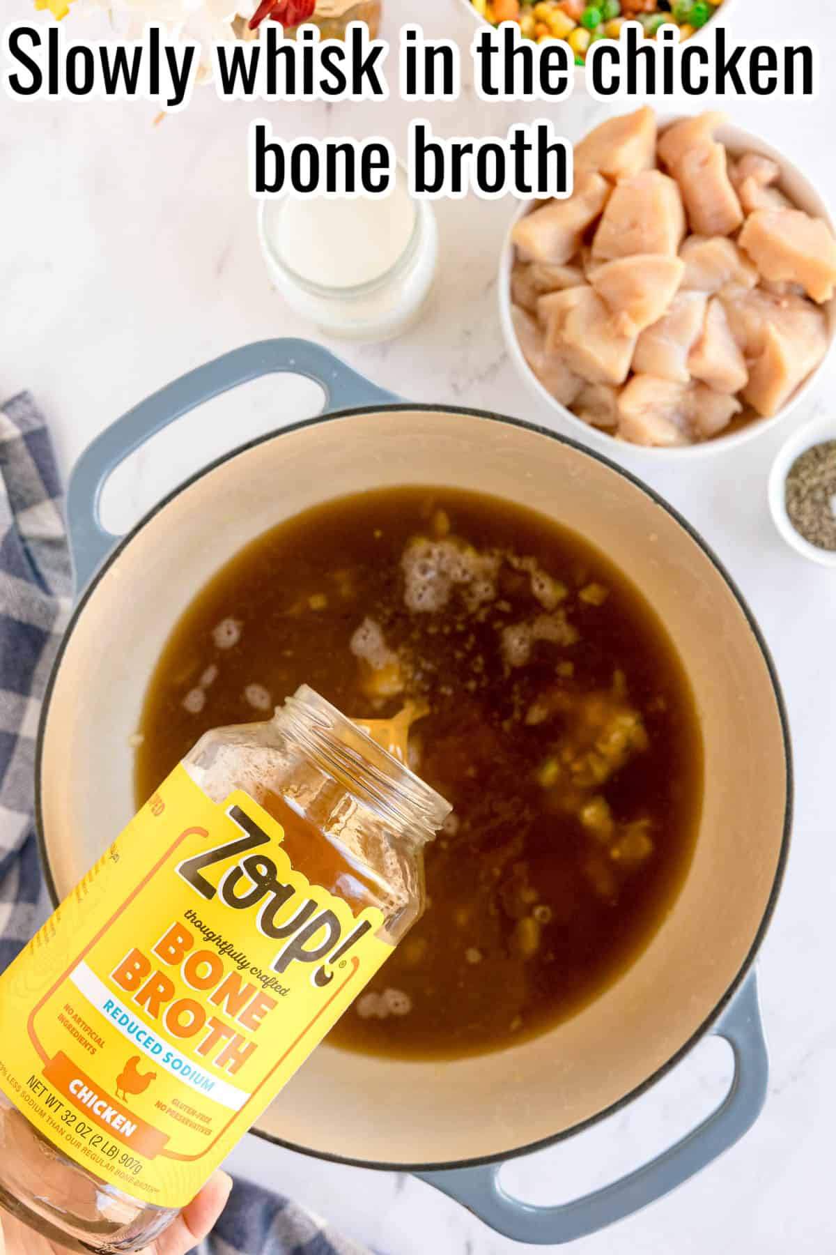 Chicken bone broth being poured into a pot. Text on the image says 'Slowly whisk in the chicken bone broth'.