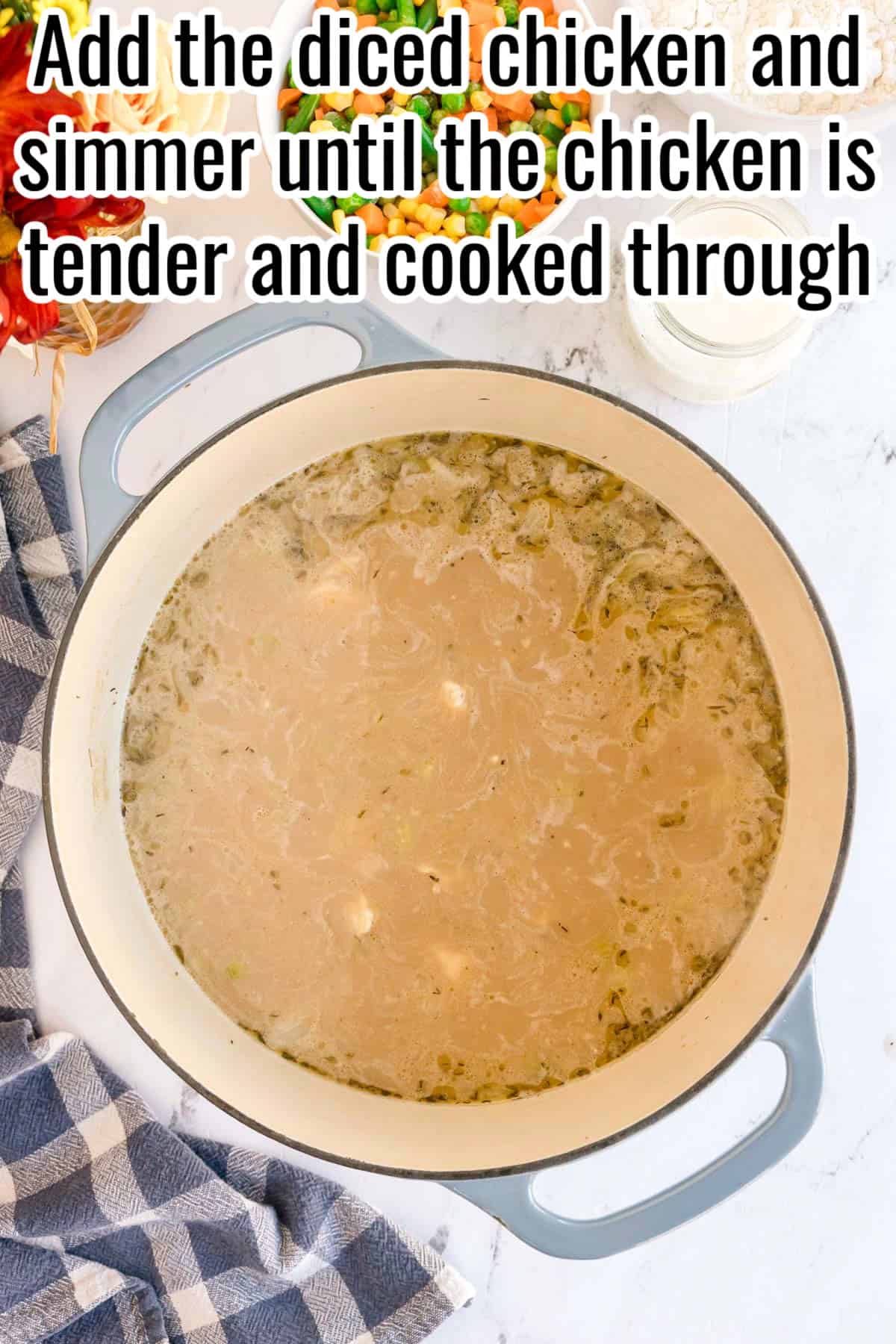 Simmering broth with diced chicken in a pot. Text on the image says 'Add the diced chicken and simmer until the chicken is tender and cooked through'.