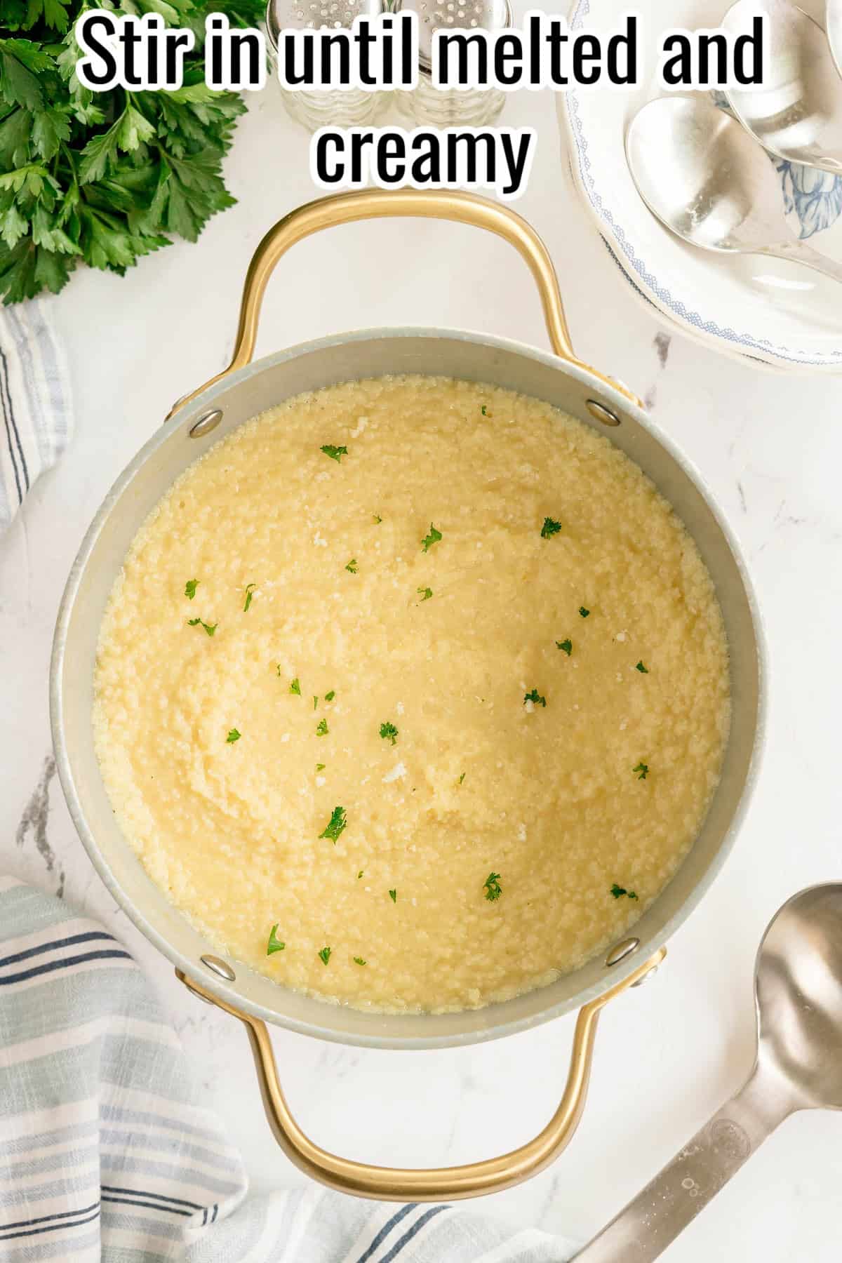 Creamy pastina in a pot with parsley on top. Text on the image says 'Stir in until melted and creamy'.