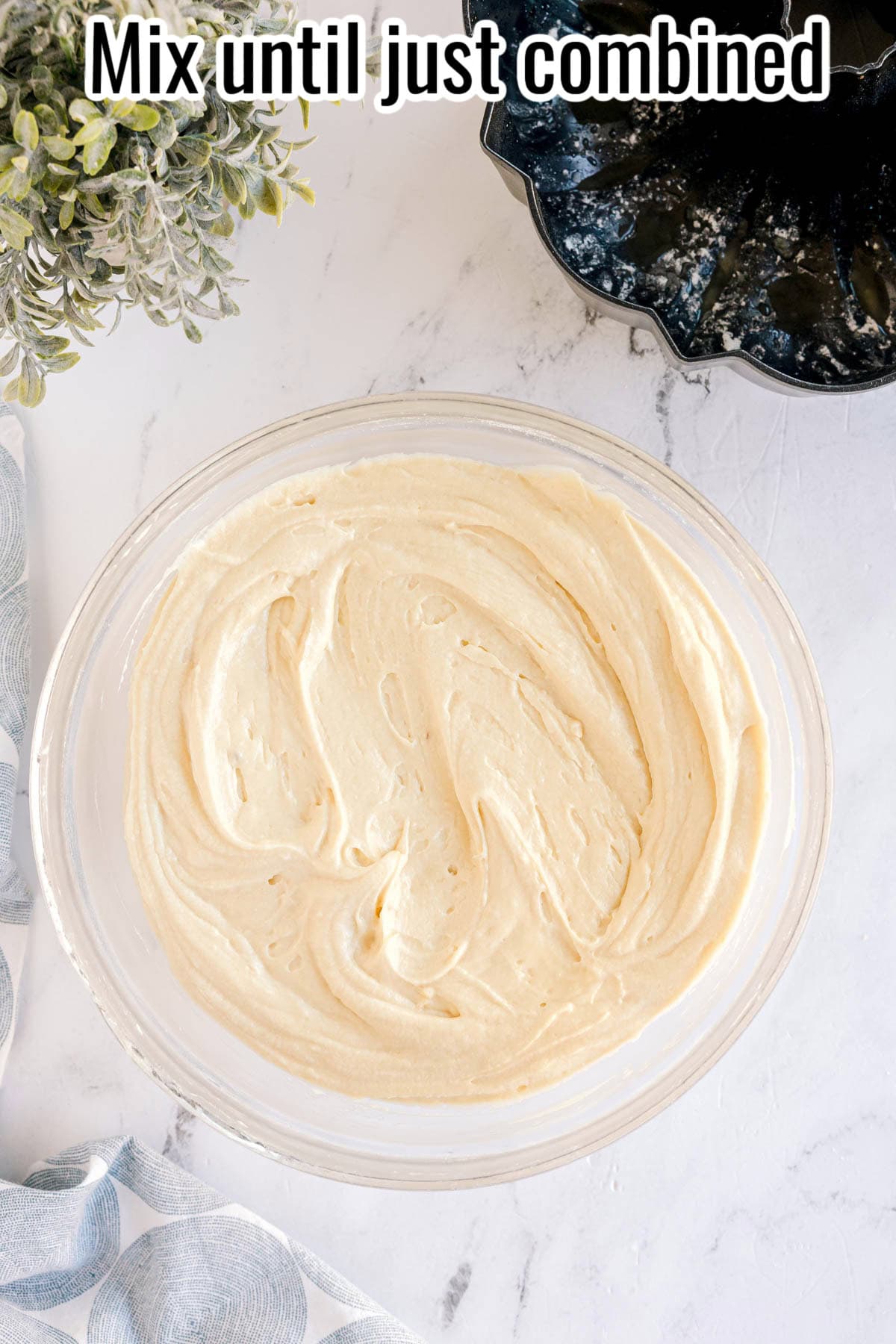 A large bowl of cake batter with a bundt pan nearby. Text on the image says 'Mix until just combined'.