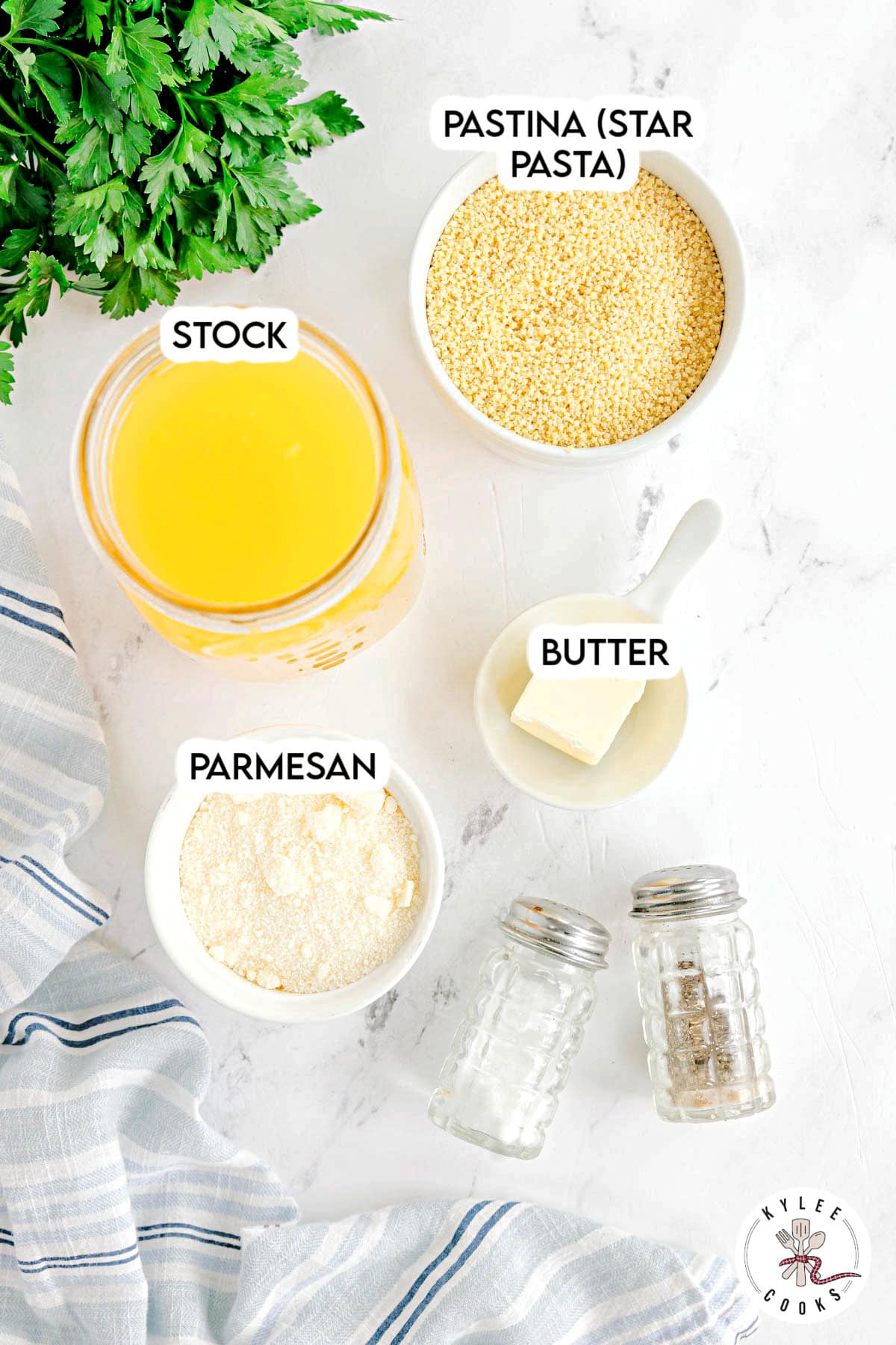 Small bowls with stock, pastina, parmesan, and butter. Salt and pepper shakers nearby. Text on the image says 'STOCK', 'PASTINA (STAR PASTA)', 'BUTTER', 'PARMESAN'.