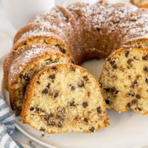 Close-up of a chocolate chip bundt cake with a few slices pulled outward.