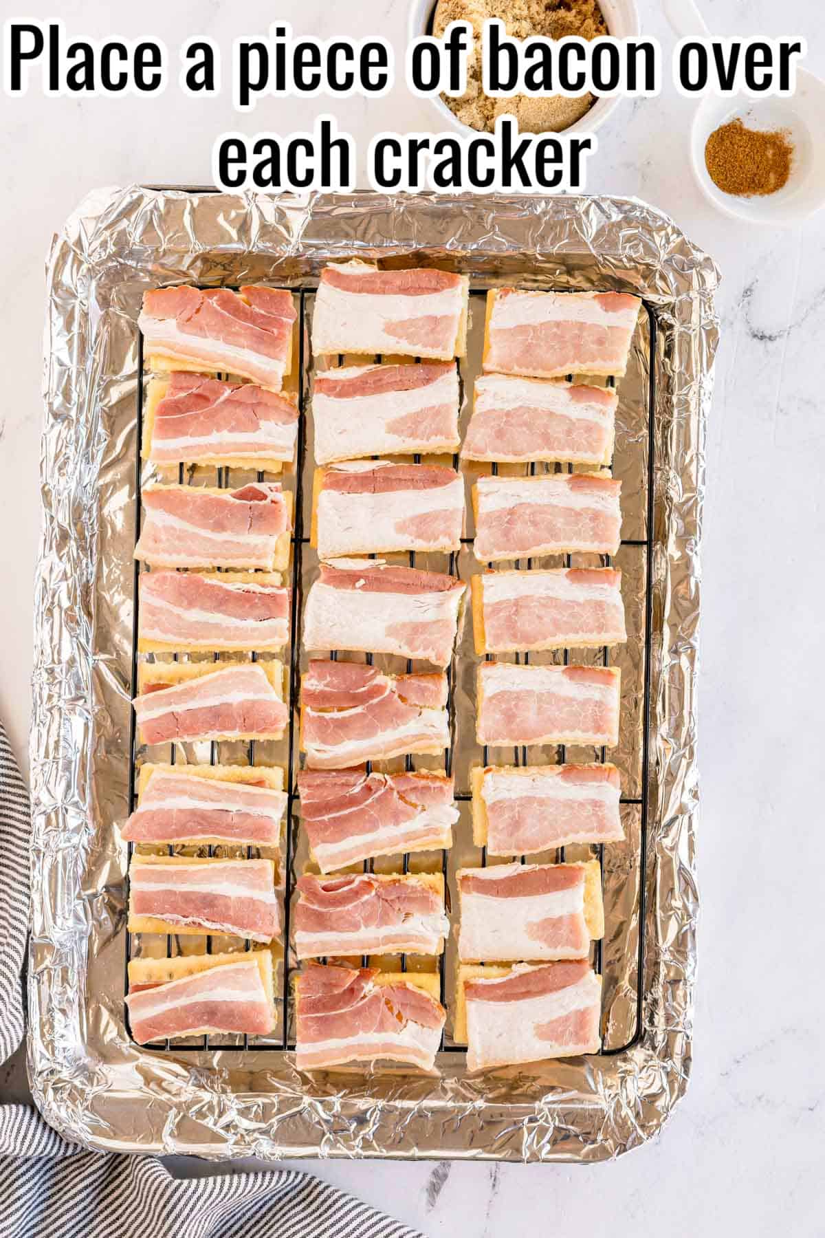 Bacon slices placed on top of crackers. Text on the image says 'Place a piece of bacon over each cracker'.