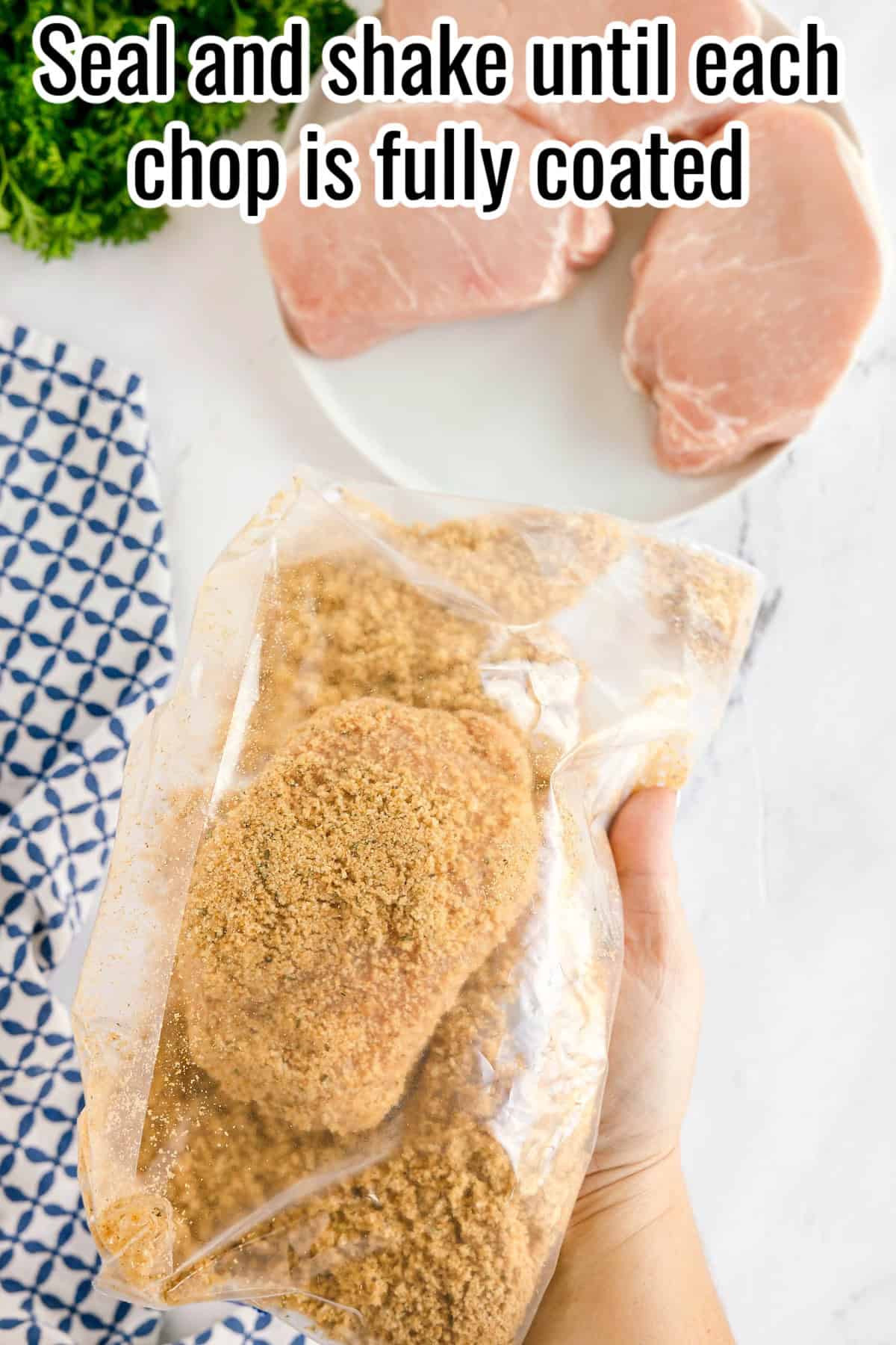 A sealed bag with a pork chop coated in breadcrumbs. Text on the image says 'Seal and shake until each chop is fully coated'.