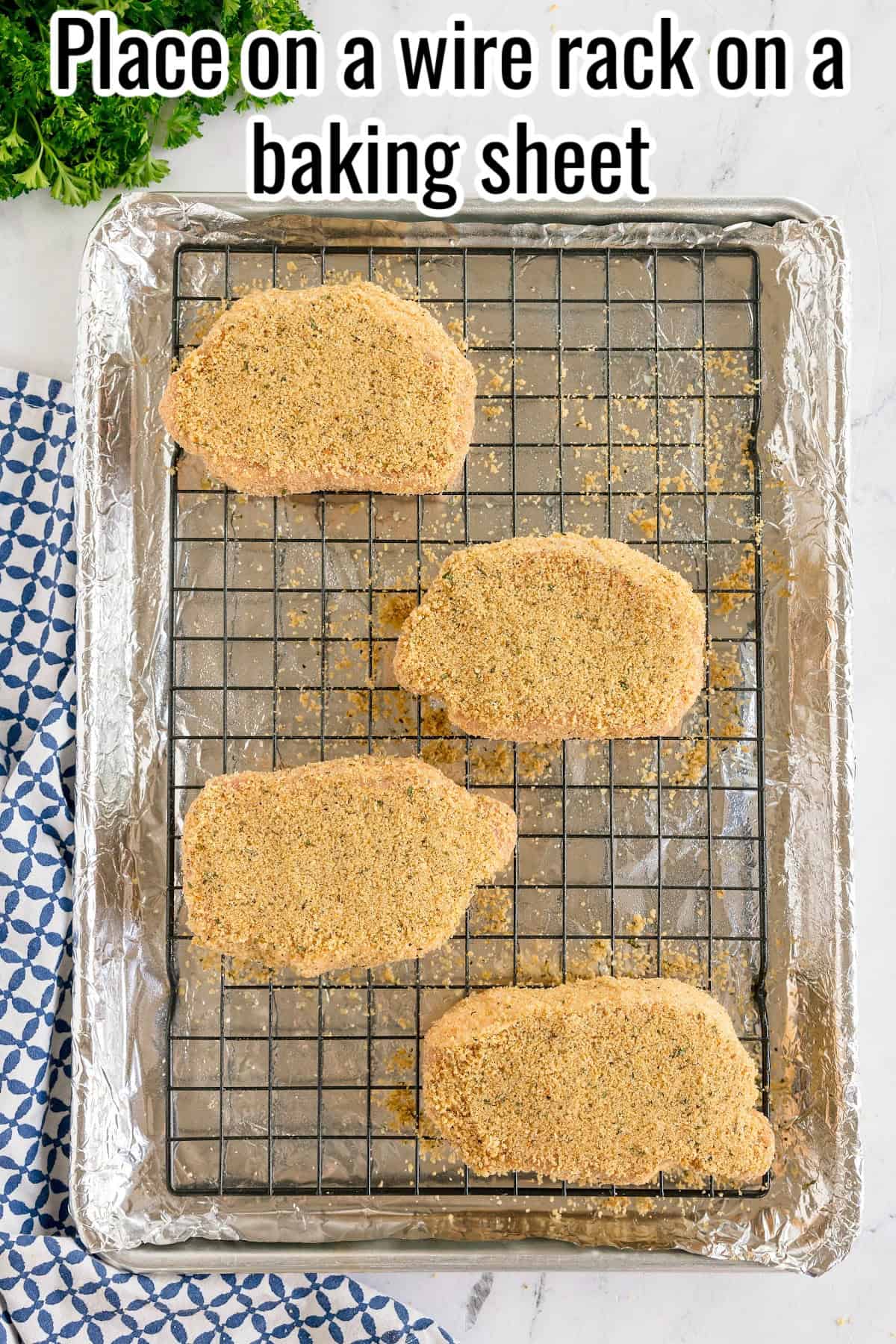 Four breaded pork chops on a wire rack over a baking sheet. Text on the image says 'Place on a wire rack on a baking sheet'.