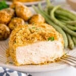 Breaded pork chop with green beans and roasted baby potatoes.