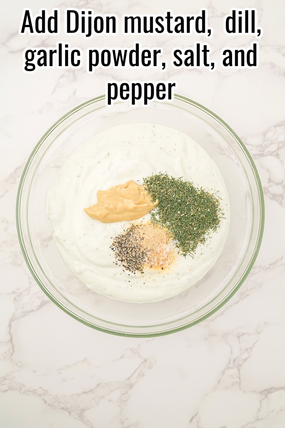 Dijon mustard, dried dill, garlic powder, salt, and pepper on top of the blended dip in a glass bowl. Text on the image says 'Add Dijon mustard, dill, garlic powder, salt, and pepper'.
