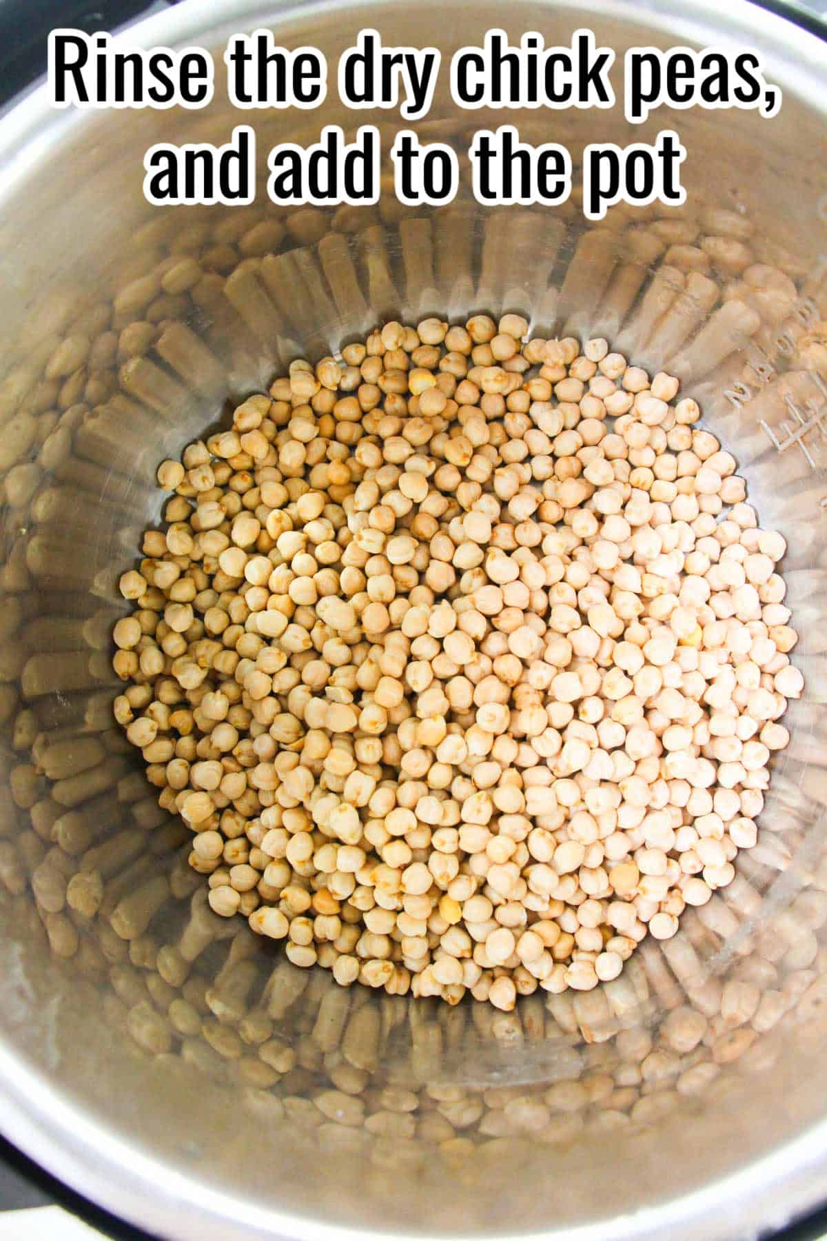 Dry chickpeas in the bottom of a metal pot. Text on the image says 'Rinse the dry chick peas, and add to the pot'.