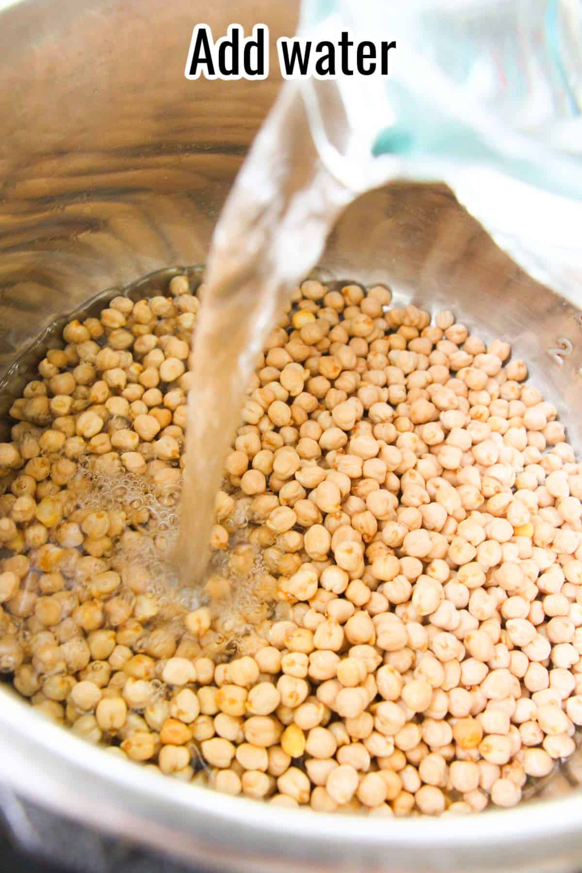 Water being poured over dry chickpeas in a pot. Text on the image says 'Add water'.