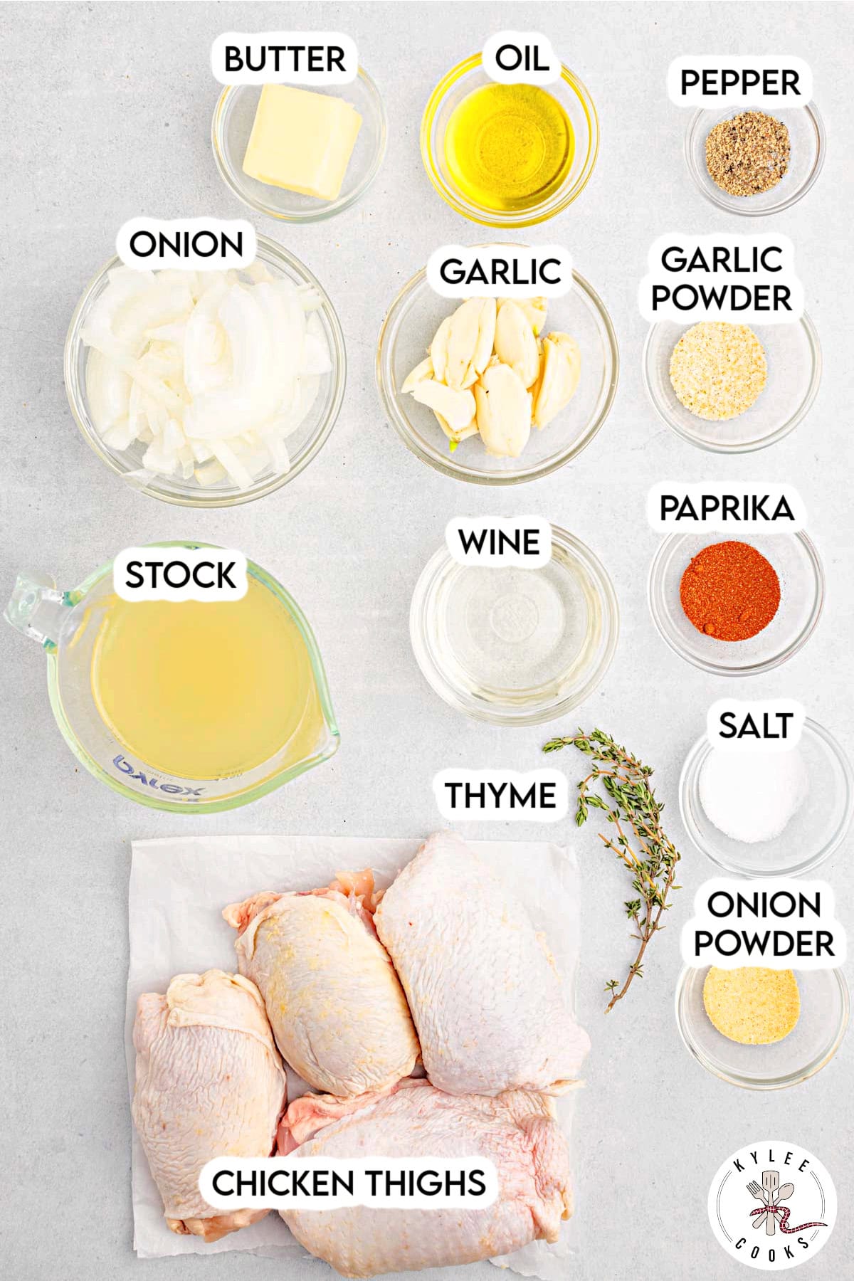 Bowls of ingredients including garlic, sliced onion, butter, oil, stock, spices, wine, thyme, and raw chicken thighs. Text on the image says 'CHICKEN THIGHS', 'GARLIC', 'THYME', etc.