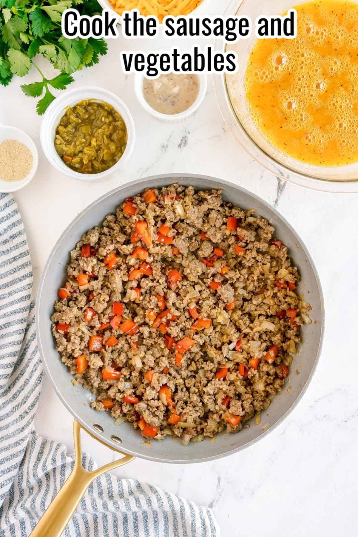 Cooked sausage and vegetables in a skillet with text overlay “Cook the sausage and vegetables.”